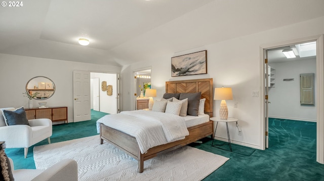 bedroom with vaulted ceiling, connected bathroom, and dark carpet