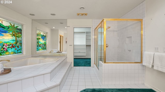 bathroom with tile patterned floors and separate shower and tub