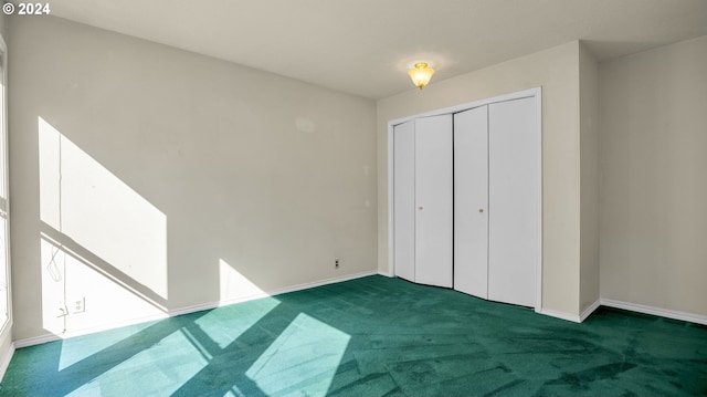 unfurnished bedroom featuring dark colored carpet and a closet