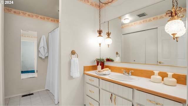 bathroom with tile patterned flooring and vanity