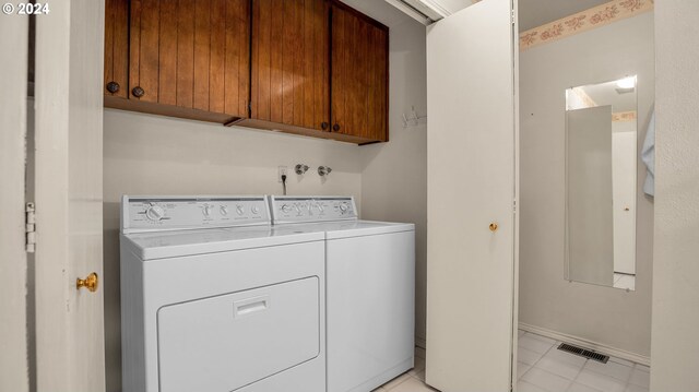 1 Bernini Ct, Lake Oswego, OR 97035 - laundry area featuring cabinet space, washer and clothes dryer, baseboards, and light tile patterned floors
