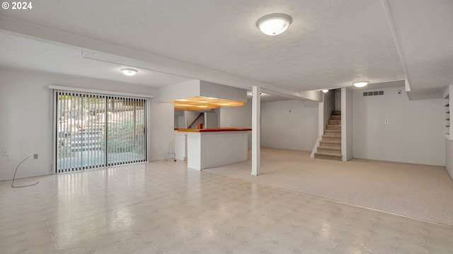 basement featuring a textured ceiling