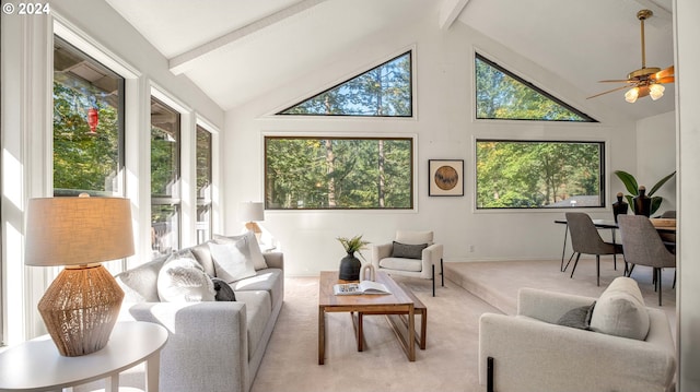 sunroom / solarium with ceiling fan and vaulted ceiling with beams