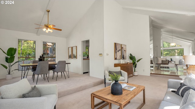 living room featuring light carpet, high vaulted ceiling, and ceiling fan