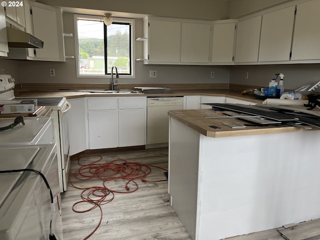 kitchen with white appliances, white cabinets, and sink