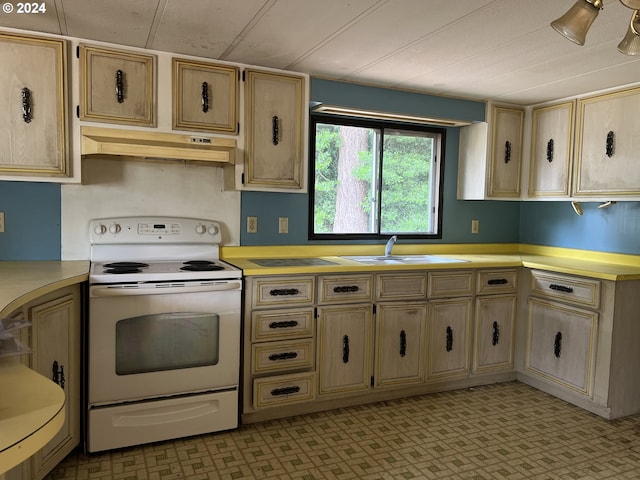 kitchen with sink, white electric range oven, and light brown cabinets