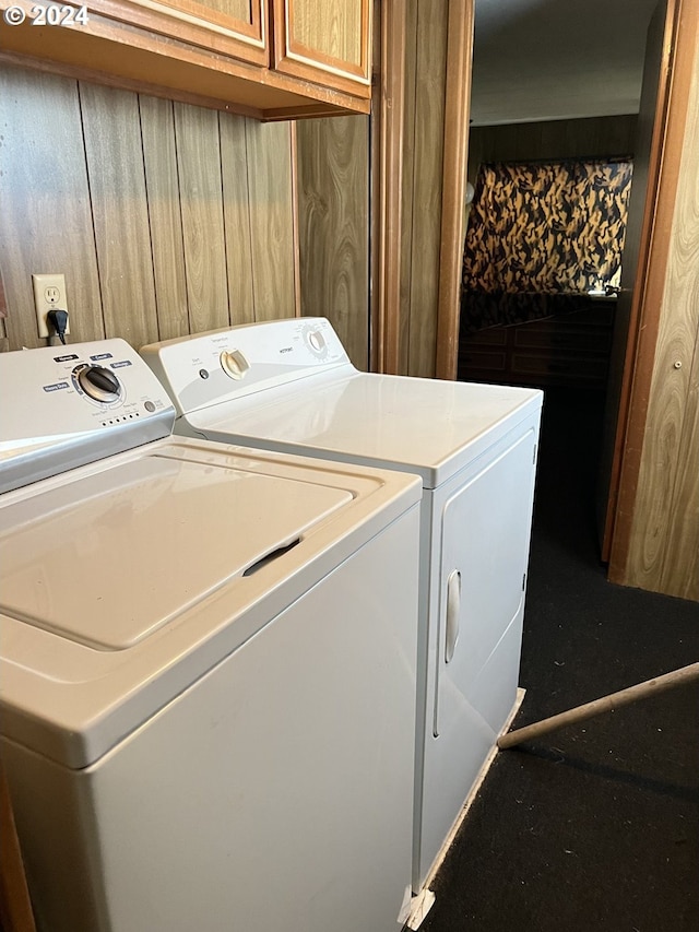 washroom with cabinets and washing machine and dryer