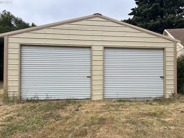 garage featuring a lawn