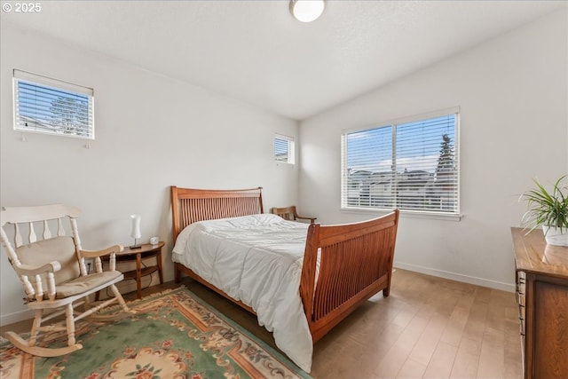 bedroom featuring light wood-type flooring and baseboards