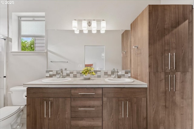 full bathroom with toilet, a stall shower, and double vanity