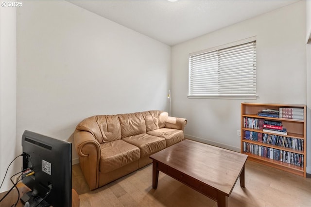 living area with light wood finished floors and baseboards