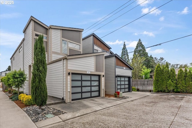 view of property exterior featuring a garage and fence