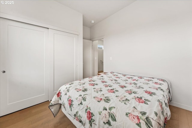 bedroom with light wood-style flooring and a closet