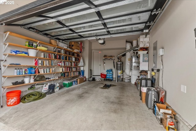 garage featuring strapped water heater and a garage door opener