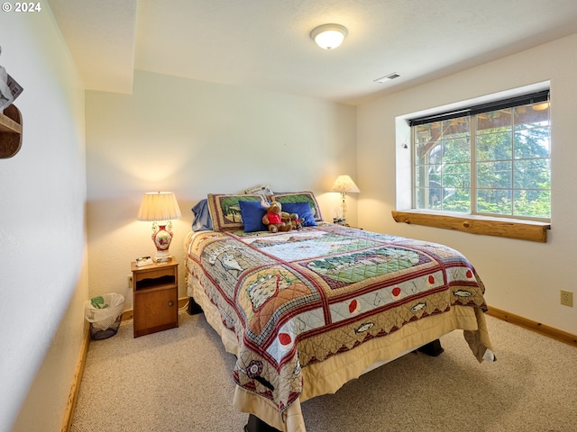 bedroom featuring light colored carpet