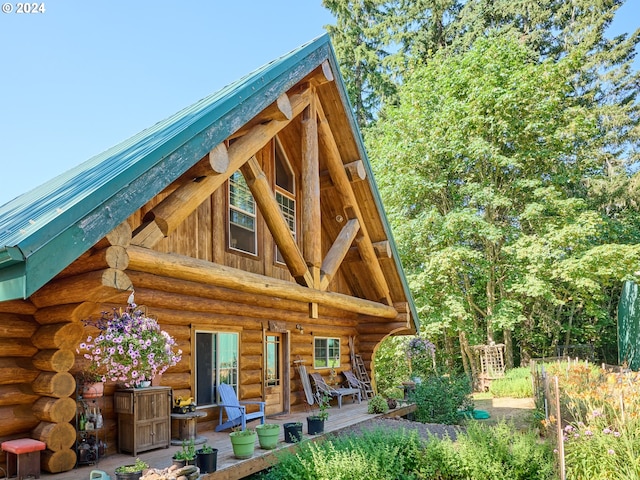 rear view of property featuring a wooden deck