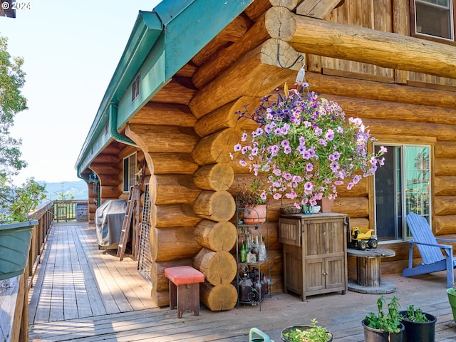 wooden deck featuring a grill