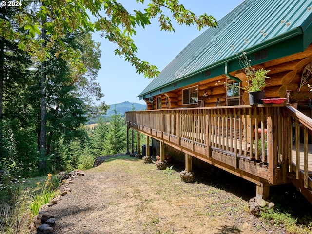 view of yard with a deck with mountain view