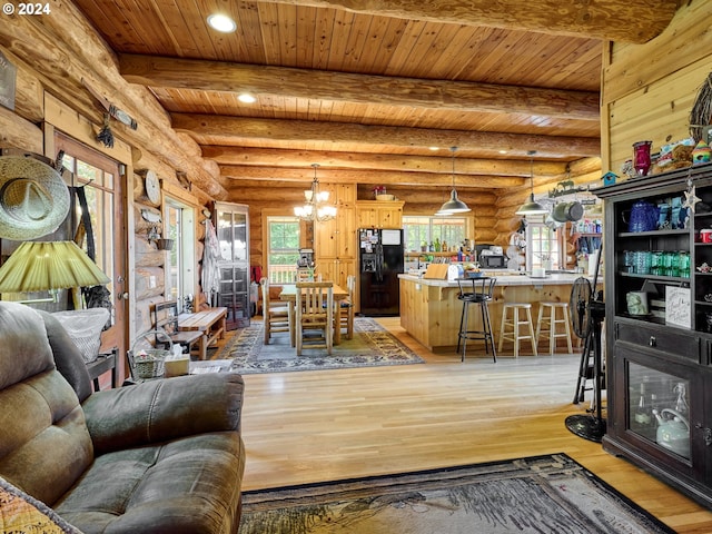 living room with wood ceiling, light hardwood / wood-style floors, a notable chandelier, rustic walls, and beam ceiling