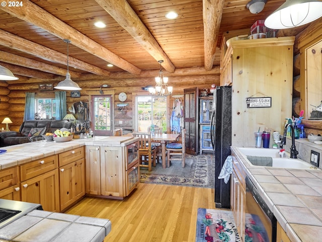 kitchen featuring tile counters, rustic walls, and light hardwood / wood-style floors