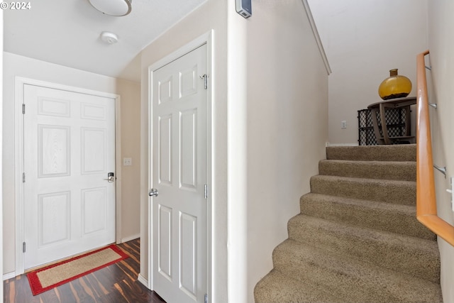 stairway with hardwood / wood-style floors