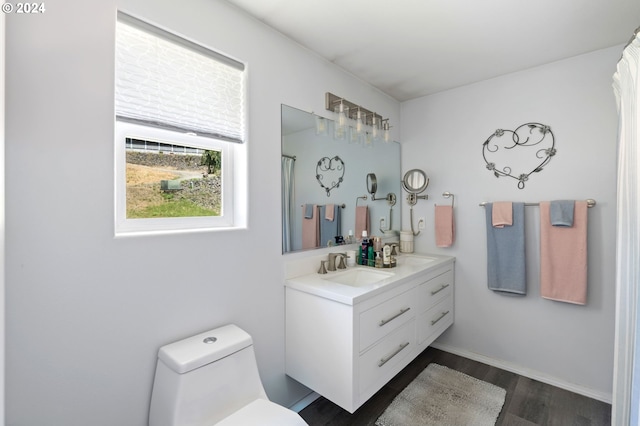 bathroom featuring hardwood / wood-style floors, vanity, toilet, and a shower with curtain