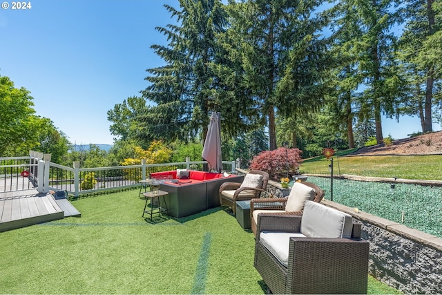 view of yard featuring outdoor lounge area and a wooden deck