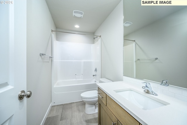 full bath featuring visible vents, toilet, vanity, wood finished floors, and  shower combination