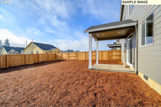 view of yard featuring a fenced backyard and a residential view