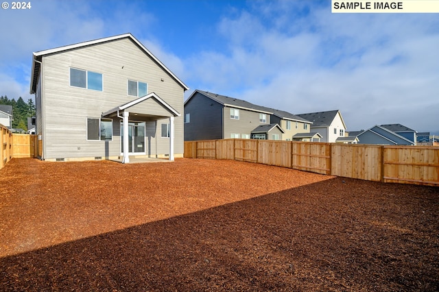 back of house with crawl space, a fenced backyard, and a residential view