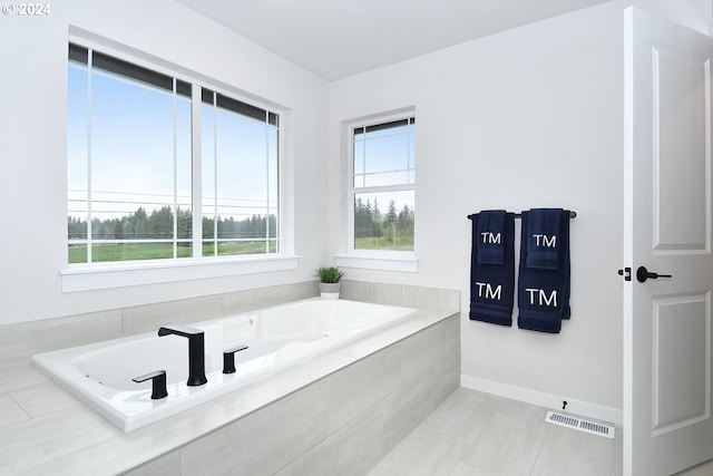 bathroom featuring tile floors and a relaxing tiled bath