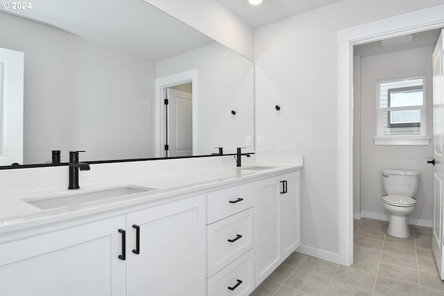 bathroom with dual bowl vanity, tile flooring, and toilet