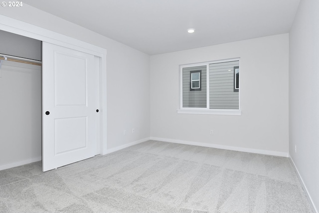 unfurnished bedroom featuring a closet and carpet floors