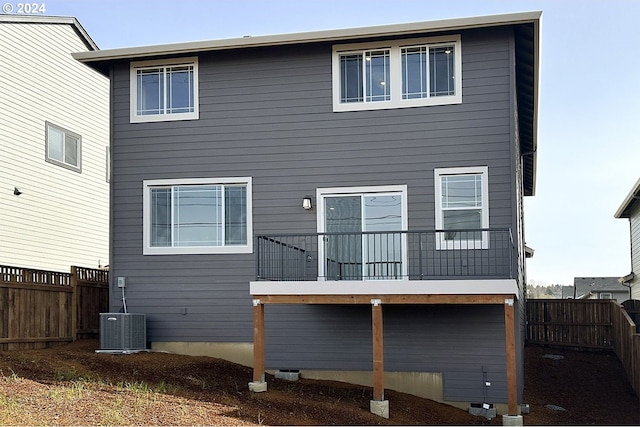 rear view of house with a deck and central AC unit