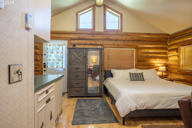 bedroom featuring rustic walls, high vaulted ceiling, and light wood-type flooring