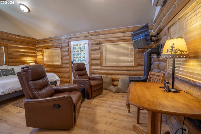 living area featuring hardwood / wood-style floors, log walls, and lofted ceiling