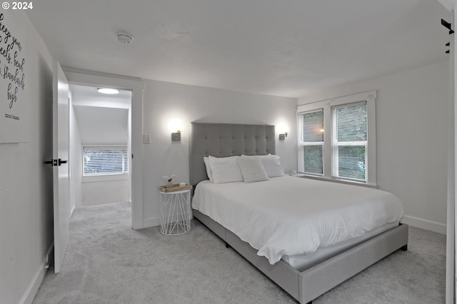 bedroom featuring light carpet