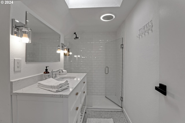 bathroom with a shower with shower door and vanity