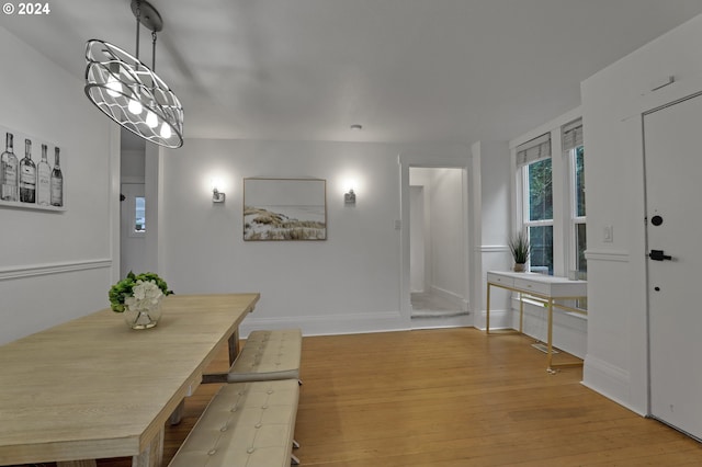 dining space with light wood-type flooring and a chandelier