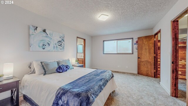 carpeted bedroom featuring a textured ceiling