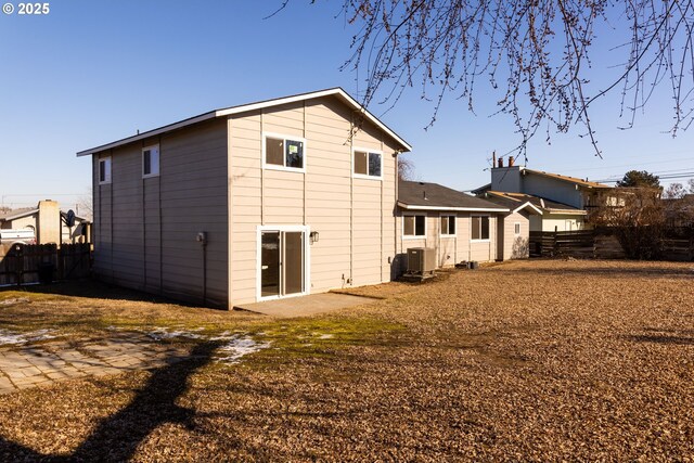 rear view of property featuring central AC