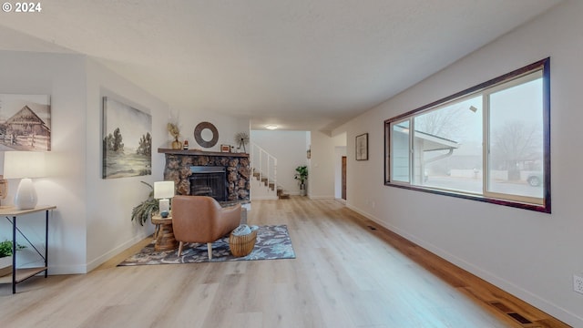 sitting room with light hardwood / wood-style floors and a fireplace