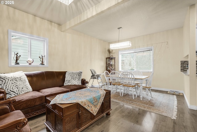 living room with beam ceiling and hardwood / wood-style floors