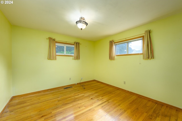 spare room featuring light wood-type flooring