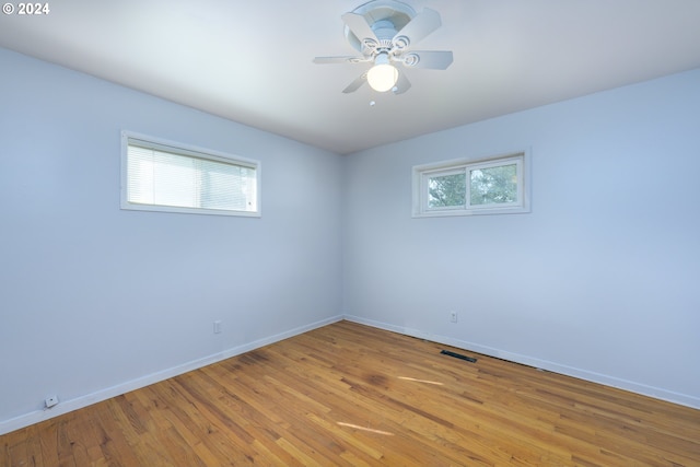 unfurnished room featuring ceiling fan, plenty of natural light, and light wood-type flooring