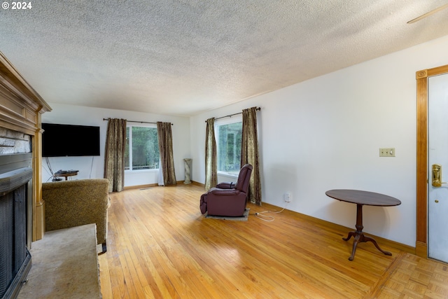 sitting room featuring a textured ceiling and hardwood / wood-style flooring