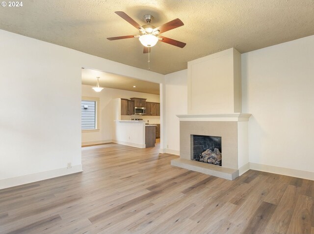 kitchen with sink, dark brown cabinets, light wood-type flooring, and kitchen peninsula