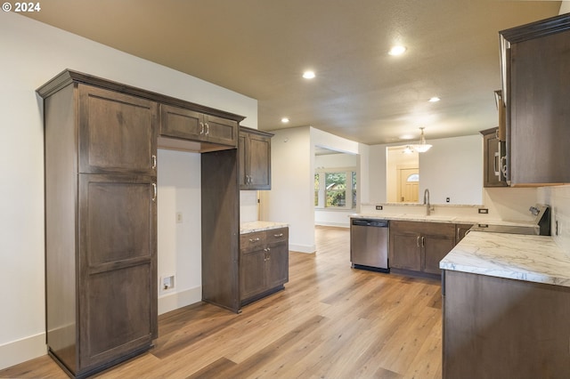 kitchen featuring light stone countertops, appliances with stainless steel finishes, light hardwood / wood-style floors, and sink