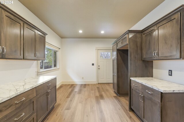 unfurnished bedroom featuring a textured ceiling, light hardwood / wood-style flooring, and a closet