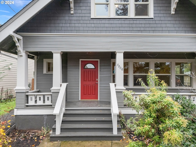 view of exterior entry with a porch